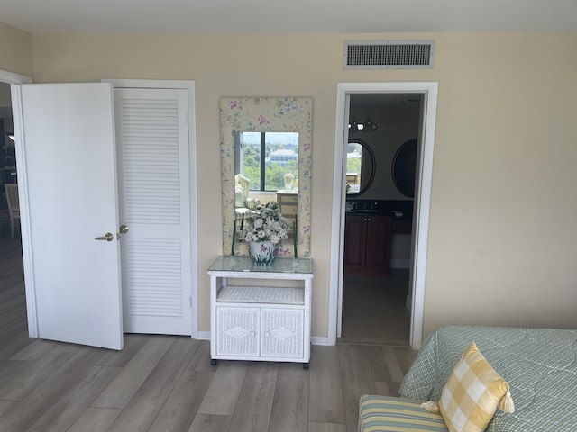 3589 S Ocean Blvd Unit 509, South Palm Beach, FL 33480 - bedroom featuring wood finished floors and ensuite bathroom