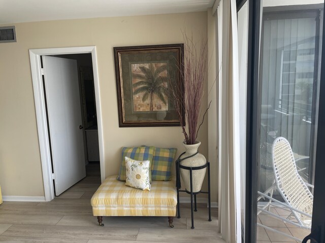 3589 S Ocean Blvd Unit 509, South Palm Beach, FL 33480 - sitting room featuring wood finished floors and baseboards