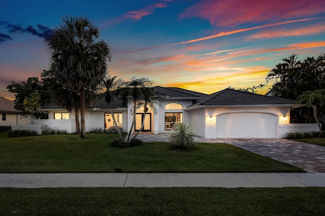 11020 Boca Woods Ln, Boca Raton, FL 33428 - view of front facade featuring stucco siding, an attached garage, decorative driveway, and a front yard