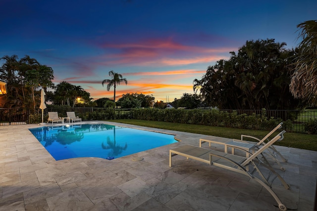 11020 Boca Woods Ln, Boca Raton, FL 33428 - pool at dusk with a patio and a fenced backyard