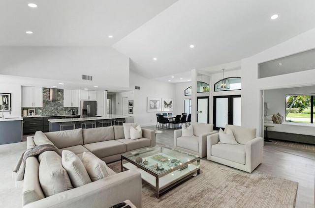 11020 Boca Woods Ln, Boca Raton, FL 33428 - living area featuring high vaulted ceiling, light wood-style flooring, and recessed lighting