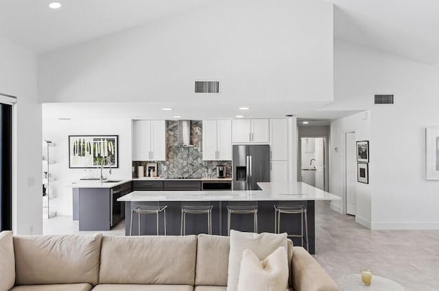 11020 Boca Woods Ln, Boca Raton, FL 33428 - kitchen with stainless steel fridge with ice dispenser, high vaulted ceiling, open floor plan, wall chimney range hood, and a sink