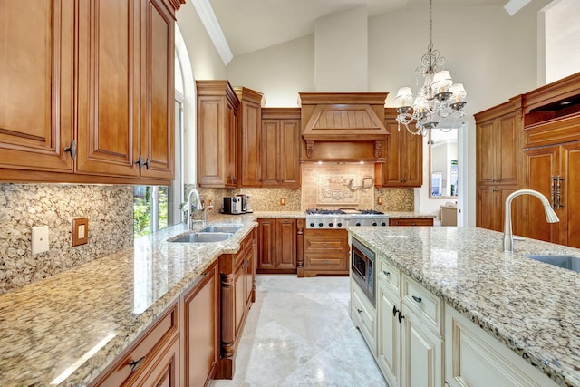 kitchen with a sink, appliances with stainless steel finishes, brown cabinets, and high vaulted ceiling