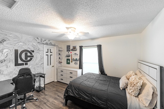 2266 SW Monterrey Ln, Port Saint Lucie, FL 34953 - bedroom with dark wood-type flooring, a textured ceiling, a ceiling fan, and a desk