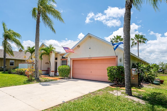 2266 SW Monterrey Ln, Port Saint Lucie, FL 34953 - view of front of property with stucco siding, a garage, driveway, and a front yard