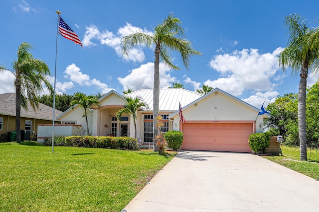 2266 SW Monterrey Ln, Port Saint Lucie, FL 34953 - ranch-style home featuring a garage, stucco siding, concrete driveway, and a front lawn
