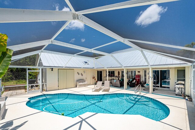 2266 SW Monterrey Ln, Port Saint Lucie, FL 34953 - swimming pool with a patio, an outdoor living space, and glass enclosure
