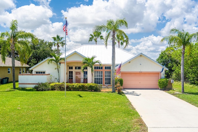 2266 SW Monterrey Ln, Port Saint Lucie, FL 34953 - view of front of house with a garage, a front lawn, driveway, and stucco siding
