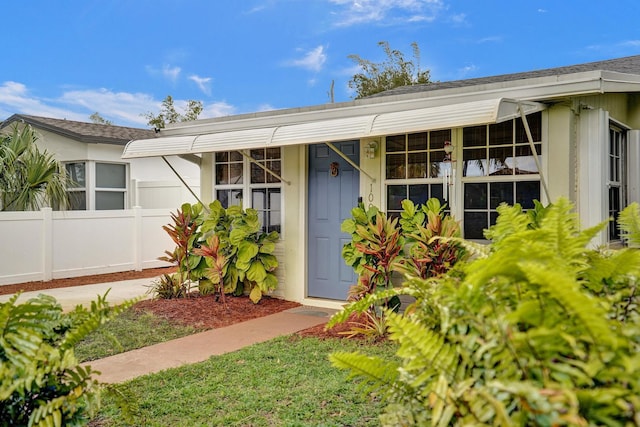 1008 SE 3rd St, Boynton Beach, FL 33435 - property entrance featuring stucco siding, fence, and a shingled roof
