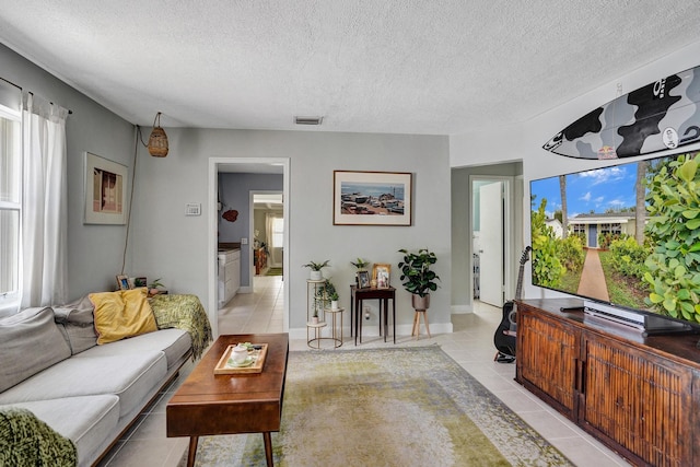 1008 SE 3rd St, Boynton Beach, FL 33435 - living area with visible vents, a textured ceiling, and light tile patterned flooring