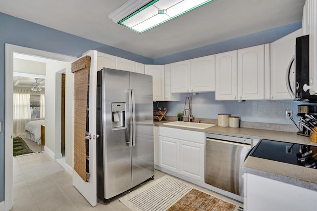 1008 SE 3rd St, Boynton Beach, FL 33435 - kitchen with appliances with stainless steel finishes, light tile patterned floors, white cabinetry, and a sink