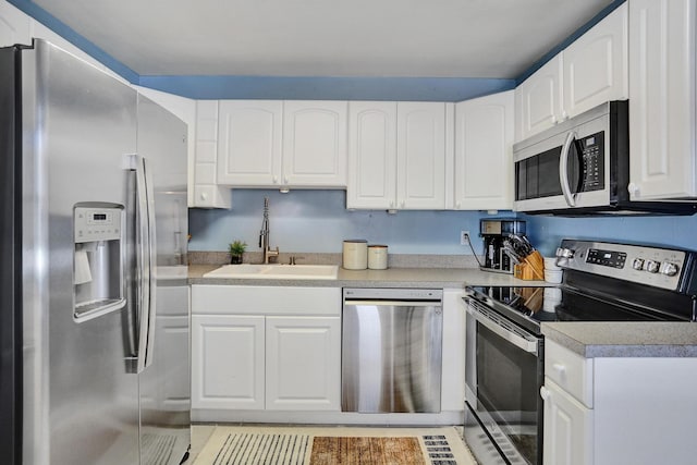 1008 SE 3rd St, Boynton Beach, FL 33435 - kitchen featuring white cabinets, stainless steel appliances, light countertops, and a sink