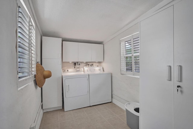 1008 SE 3rd St, Boynton Beach, FL 33435 - clothes washing area featuring washer and clothes dryer, a textured ceiling, light tile patterned flooring, cabinet space, and baseboards
