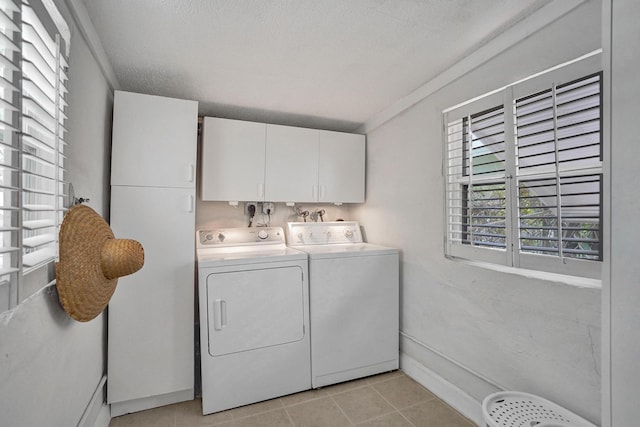 1008 SE 3rd St, Boynton Beach, FL 33435 - washroom featuring a textured ceiling, separate washer and dryer, light tile patterned floors, cabinet space, and baseboards