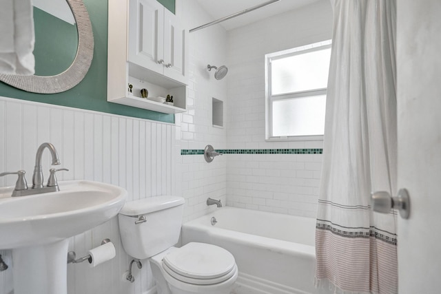 1008 SE 3rd St, Boynton Beach, FL 33435 - bathroom with a sink, toilet, a wainscoted wall, and shower / bath combination with curtain