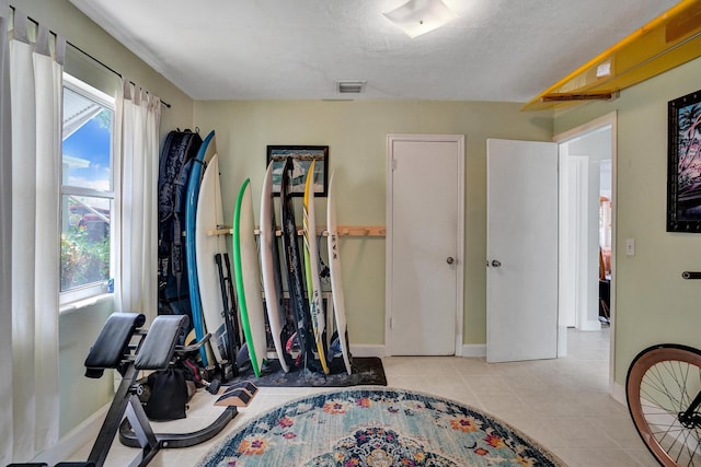 1008 SE 3rd St, Boynton Beach, FL 33435 - workout area featuring baseboards and light tile patterned flooring