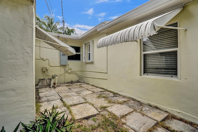 1008 SE 3rd St, Boynton Beach, FL 33435 - view of side of home with stucco siding and a patio