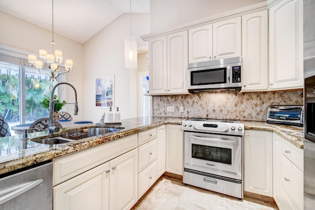 kitchen featuring a sink, lofted ceiling, decorative backsplash, light stone countertops, and appliances with stainless steel finishes