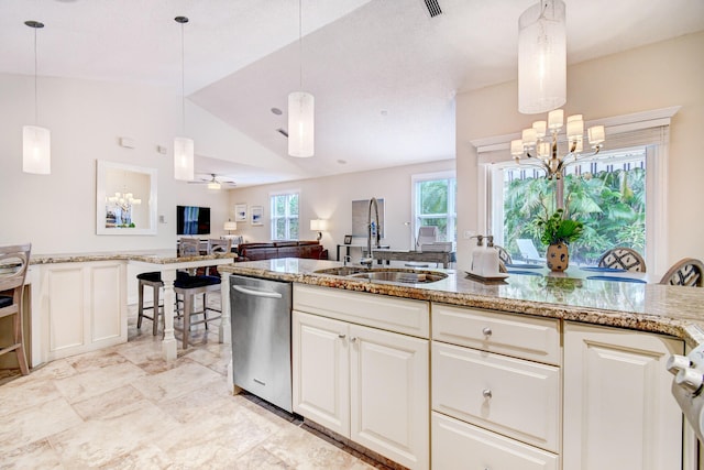 kitchen featuring stainless steel dishwasher, light stone counters, a sink, pendant lighting, and lofted ceiling