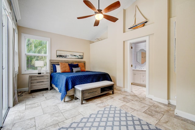 bedroom with ensuite bath, baseboards, a ceiling fan, and high vaulted ceiling