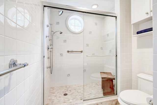 full bath featuring toilet and a stall shower