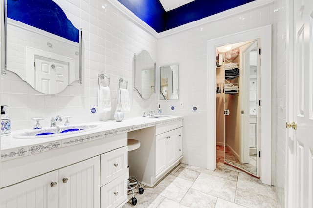 17586 Tiffany Trace Dr, Boca Raton, FL 33487 - bathroom with double vanity, tasteful backsplash, a spacious closet, tile walls, and marble finish flooring