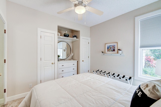 bedroom with baseboards and a ceiling fan