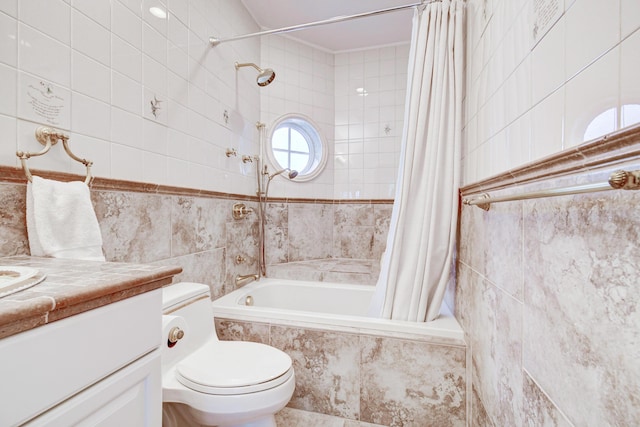 full bath featuring tile walls, vanity, tiled shower / bath combo, and toilet