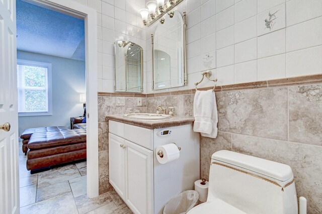 17586 Tiffany Trace Dr, Boca Raton, FL 33487 - ensuite bathroom with tile walls, vanity, and toilet