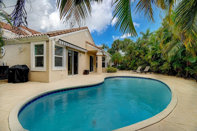 outdoor pool with a patio area