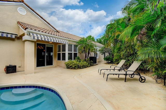 pool featuring a patio area and central AC unit
