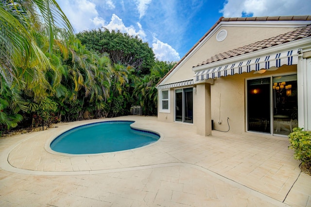 outdoor pool with a patio area