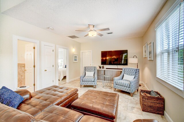 17586 Tiffany Trace Dr, Boca Raton, FL 33487 - living area with ceiling fan, healthy amount of natural light, baseboards, and a textured ceiling