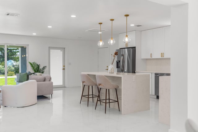 2771 NE 53rd St, Lighthouse Point, FL 33064 - kitchen featuring stainless steel appliances, open floor plan, visible vents, white cabinetry, and light countertops