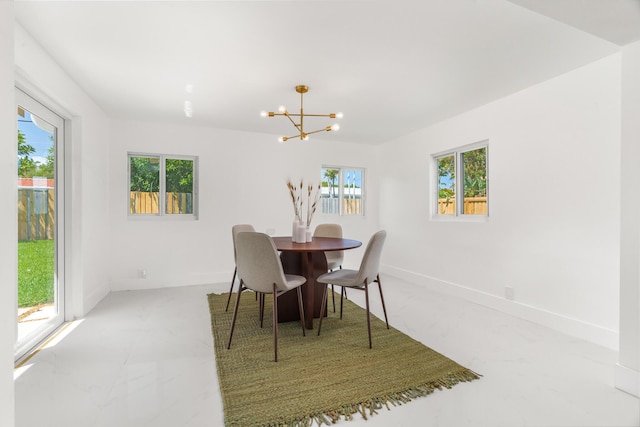 2771 NE 53rd St, Lighthouse Point, FL 33064 - dining space with a wealth of natural light, baseboards, and an inviting chandelier