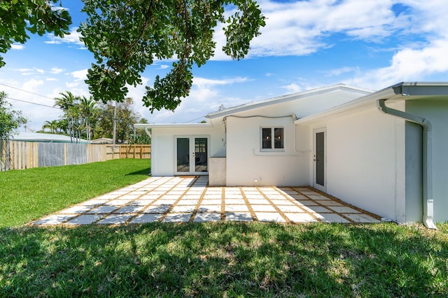 2771 NE 53rd St, Lighthouse Point, FL 33064 - rear view of property featuring a lawn, fence, a patio area, and stucco siding