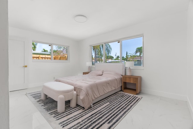2771 NE 53rd St, Lighthouse Point, FL 33064 - bedroom featuring baseboards, marble finish floor, and multiple windows