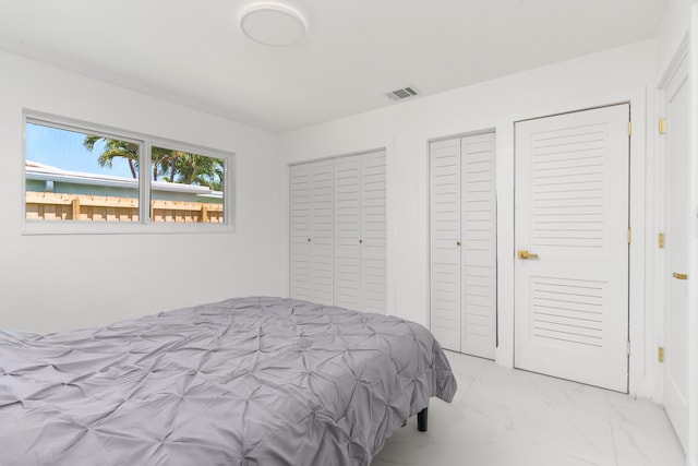 2771 NE 53rd St, Lighthouse Point, FL 33064 - bedroom with two closets, visible vents, and marble finish floor