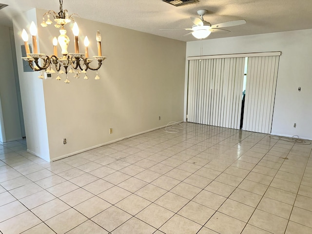 2511 W Dudley Dr Unit B, West Palm Beach, FL 33415 - spare room featuring a textured ceiling, baseboards, visible vents, ceiling fan with notable chandelier, and light tile patterned floors