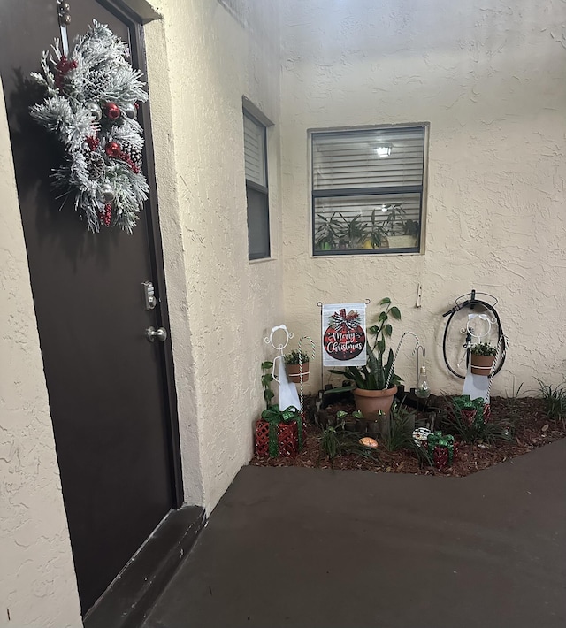 entrance to property with stucco siding