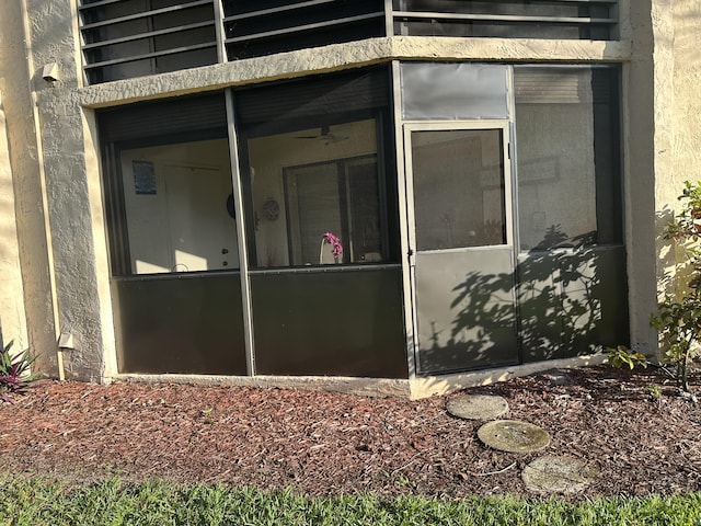 property entrance featuring stucco siding