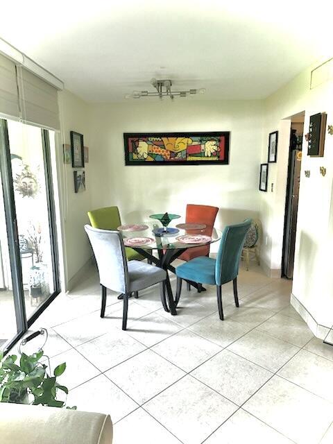 dining space with a wealth of natural light and light tile patterned floors