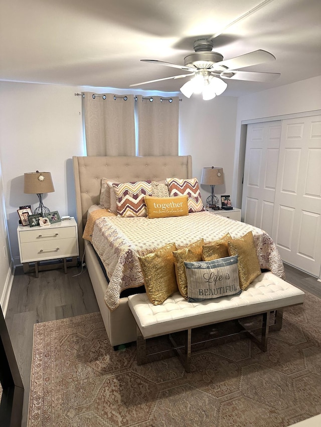 bedroom featuring wood finished floors, a closet, a ceiling fan, and baseboards