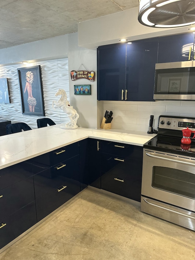 3570 S Ocean Blvd Unit 205, South Palm Beach, FL 33480 - kitchen featuring stainless steel appliances, dark cabinets, blue cabinets, modern cabinets, and decorative backsplash