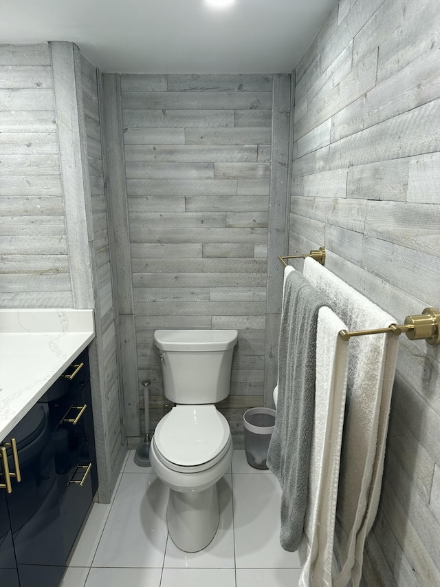 3570 S Ocean Blvd Unit 205, South Palm Beach, FL 33480 - bathroom with tile patterned floors, wooden walls, vanity, and toilet