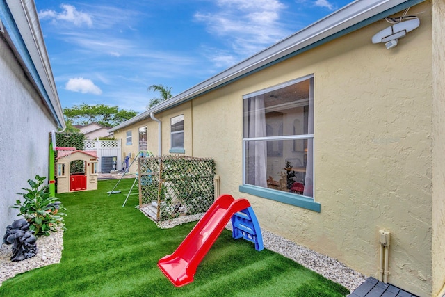 1275 Waterway Cove Dr, Wellington, FL 33414 - view of play area with a lawn and fence