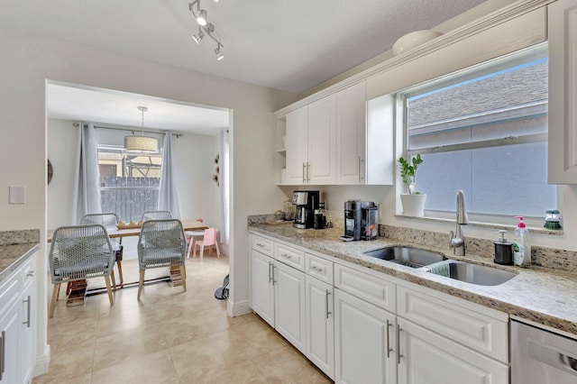 1275 Waterway Cove Dr, Wellington, FL 33414 - kitchen featuring light stone countertops, stainless steel dishwasher, a sink, and white cabinetry