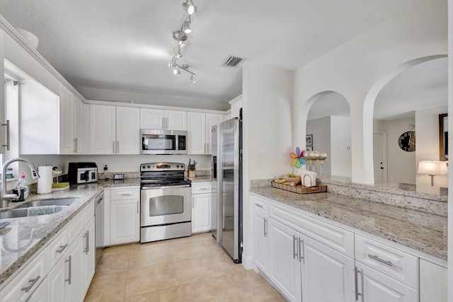 1275 Waterway Cove Dr, Wellington, FL 33414 - kitchen with visible vents, a sink, white cabinetry, and appliances with stainless steel finishes