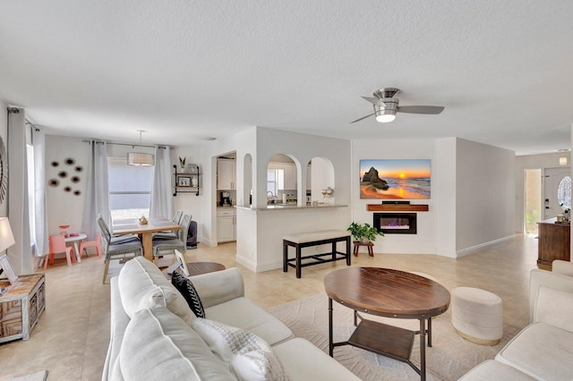 1275 Waterway Cove Dr, Wellington, FL 33414 - living area with light tile patterned flooring, a textured ceiling, and ceiling fan