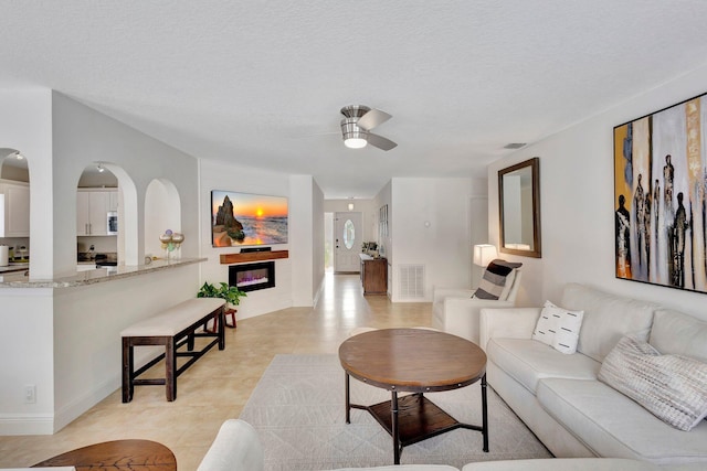 1275 Waterway Cove Dr, Wellington, FL 33414 - living room featuring ceiling fan, baseboards, visible vents, and light tile patterned floors